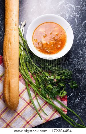 Vegetables And Meat In Red Beetroot Soup Or Borsch In White Plate On Dark Marble Background.