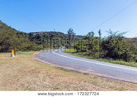 Rural Asphalt Road Curving Through Rural Landscape