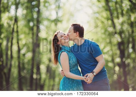 Young happy loving couple having fun and enjoying in park