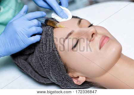 procedure Plasmolifting injection. plasma injection into the skin of the forehead of the patient