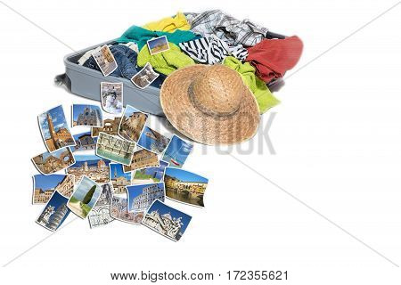 Studio shot of a suitcase with scattered clothing and straw hat. Photos of Tuscany (Italy) landmarks are lying in front of the suitcase. Everything is on a white background.