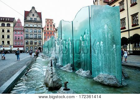 Wroclaw Poland - July 16 2014: Fountain on the Market Square of Wroclaw in Poland. Wroclaw is the historical capital of Silesia. Travel vacation concept.
