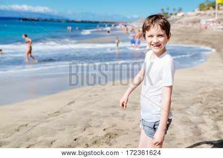 Happy 7 Years Boy Child Walking On The Beach.