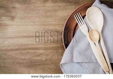 Rustic Kitchen Utensils: the Ceramic Plates and Wooden Cutlery on Wooden Background. Home Wares. Kitchen Decor in Rustic Style. View From Above With Copy Space.