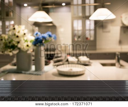Blurred background. Modern kitchen with tabletop and space for you. Empty wooden table and blurred kitchen background for display or montage your products