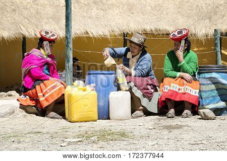 Indigenous women selling chicha (fermented corn beer) at the market in the Quechua community of Patacancha. October 21 2012 - Patacancha Ollantaytambo Peru