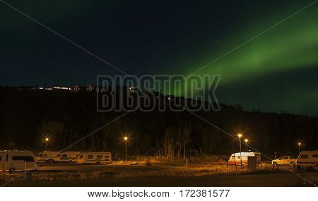 BJORKLIDEN, SWEDEN ON SEPTEMBER 20. View from the parking lot downhill the Hotel Fjallet on September 20, 2016 in Bjorkliden, Sweden. Aurora borealis, Northern Lights above the Hotel. Caravans this side. Editorial use.