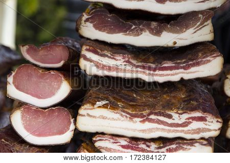 Home made smoked bacon and smoked meat in a street marketselective focus and small depth of field