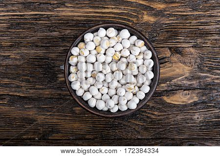 White Turkish chickpeas in a bowl on a wooden background