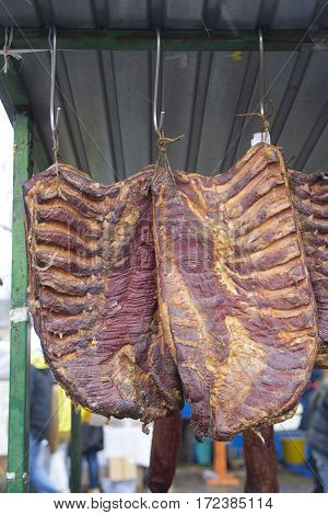 Home made smoked bacon in a street market selective focus and small depth of field