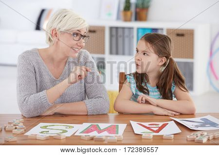 Child Studying Alphabet With Teacher