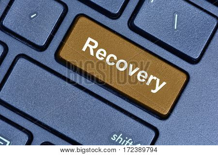 Recovery word on computer keyboard button closeup
