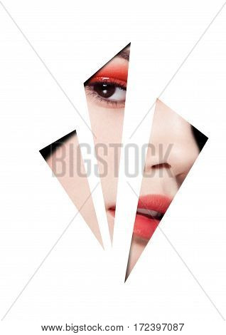 Beauty red eyes and lips makeup fashion model on black background looking through three white triangles. Creative artwork