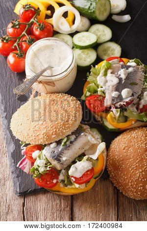 Fishburger With Herring, Gravy And Fresh Vegetables Close-up. Vertical
