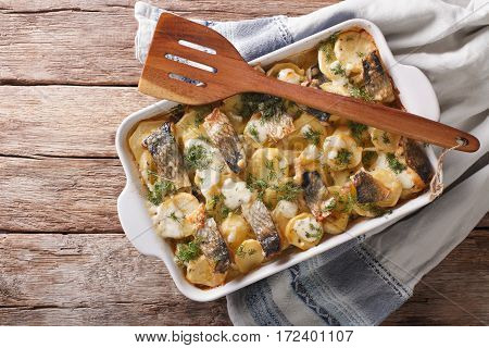 Finnish Food: Casserole With Potatoes And Herring Close Up In Baking Dish. Horizontal Top View