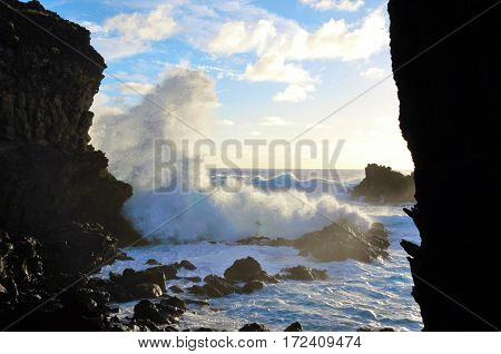 Waves breaking at the cliffs in front of the Ana Kai Tangata Cave close to Hanga Roa in Rapa Nui Easter Island in Chile South America