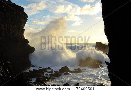 Waves breaking at the cliffs in front of the Ana Kai Tangata Cave close to Hanga Roa in Rapa Nui Easter Island in Chile South America
