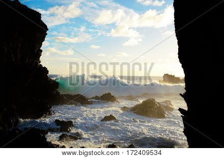 Waves breaking at the cliffs in front of the Ana Kai Tangata Cave close to Hanga Roa in Rapa Nui Easter Island in Chile South America