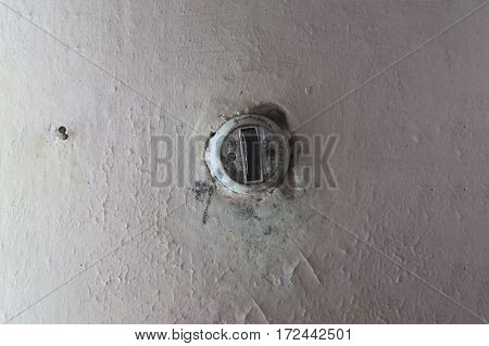Belarus February 2017 Old Soviet postwar switch light wall cracked paint peeled off the wall the Soviet rarity old thing an old Soviet piece of furniture