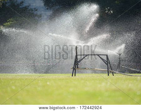 Sprinkler watering the grass of the football field