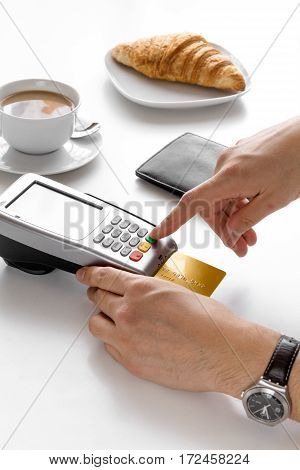 Payment by credit card for business break in cafe on white table background