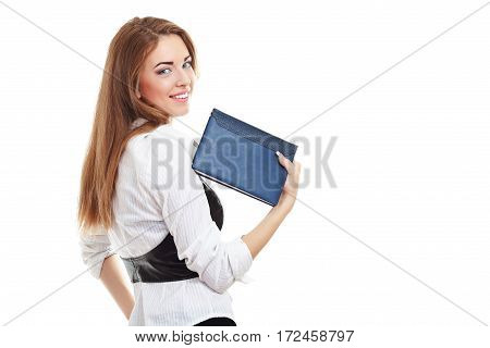 portrait of young businesswoman standing back turned with note book in hand looking over her shoulder isolated on whitebackground in photostudio