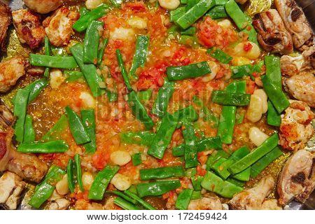 Paella from Spain recipe process ad vegetables green beans and tomato
