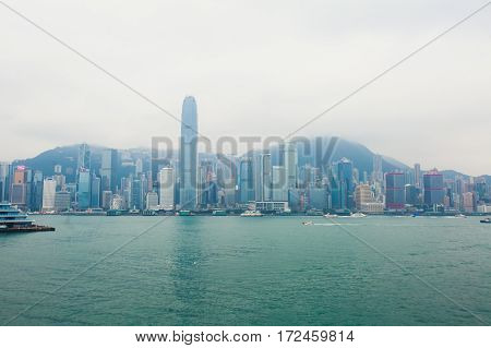 Beautiful super wide-angle summer aerial view View of Hong Kong island skyline, Victoria Bay harbor, with skyscrapers, blue sky and scenery beyond the city, seen from Kowloon island observation Deck