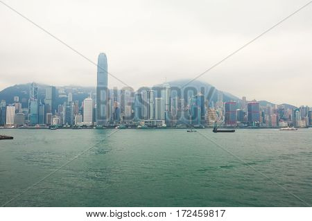 Beautiful super wide-angle summer aerial view View of Hong Kong island skyline, Victoria Bay harbor, with skyscrapers, blue sky and scenery beyond the city, seen from Kowloon island observation Deck