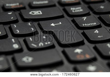 Detail closeup view of black keyboard key Enter