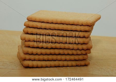 Stacked plain bisuits on a wooden cutting board