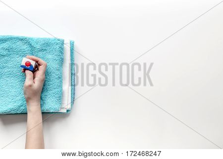 Blue towels pile with washing powder in laudry set on white table background top view mockup