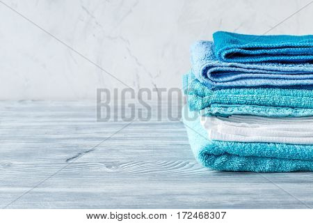 Blue towels set in laudry on gray table backgruond mock-up