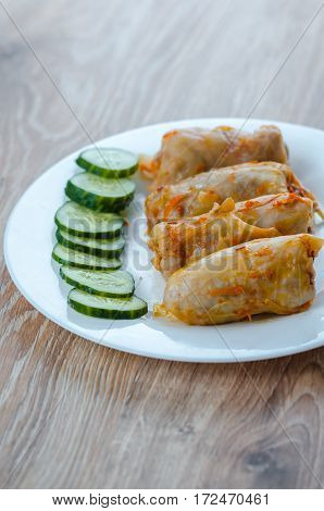 stuffed cabbage is a traditional Ukrainian meals stewed cabbage leaves stuffed with ground meat and rice with sour cream with sliced cucumbers