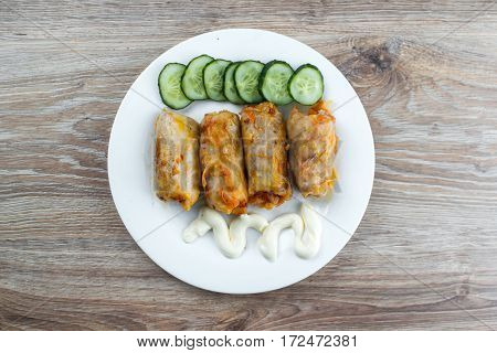 stuffed cabbage is a traditional Ukrainian meals stewed cabbage leaves stuffed with ground meat and rice with sour cream with sliced cucumbers