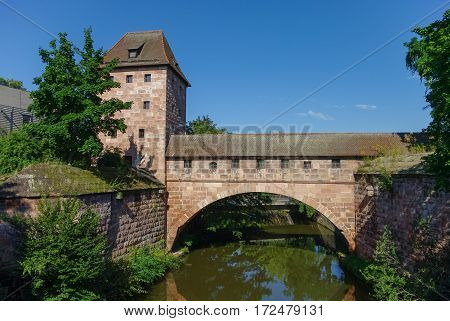 Old City Walls With An Arch Reflected In The Pegnitz River, Near Steubenbrucke Bridge, Historic Cent