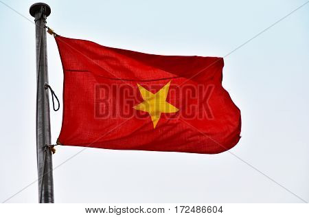The Vietnamese national flag and sky which are blown by wind