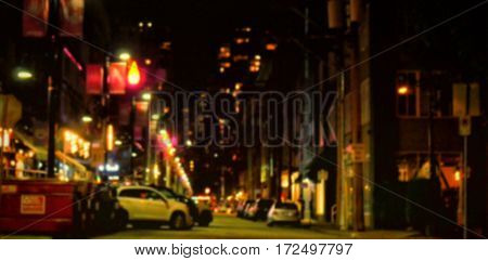 Car parked on street amidst buildings in city at night
