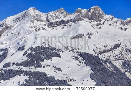 The Rigidalstock Spitzmann Schyeggstock and Grosser Sattelistock summits in the Swiss Alps in wintertime, view from Mt. Titlis. The Titlis is a mountain in Switzerland, located on the border between the Swiss cantons of Obwalden and Bern.