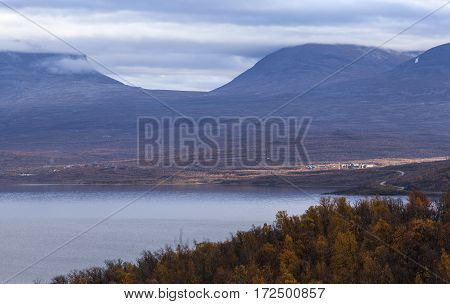 Nordic mountains in overcast weather, autumn fall. Well known landmark in northern Sweden along the road Narvik - Kiruna. Abisko in the sunlight.