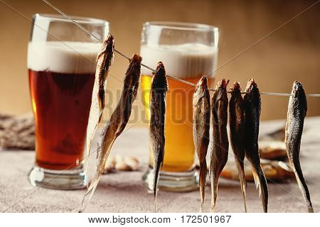 Dried fish and beer on the table