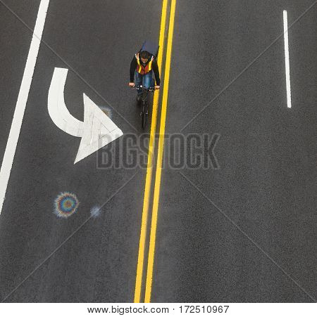 NEW YORK USA - May 03 2016: Road markings on asphalt on the street of Manhattan in New York City. Сyclist moves along the road. Iridescent spot of gasoline on asphalt
