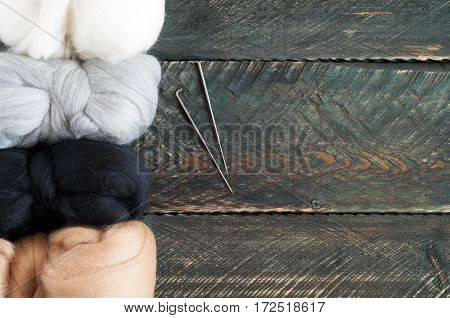 Wool for felting on old wooden background. Top view