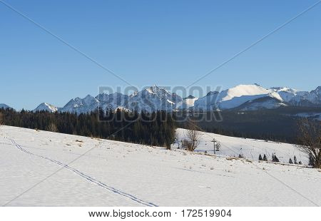 Winter mountains covered with snow view from a big meadow in Tatry mountains in Poland