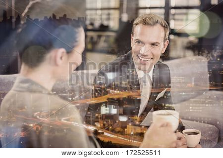 Businessman and businesswoman having a discussion during breaktime in office