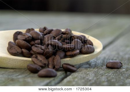 Chicchi di caffè in un cucchiaio di legno 01
