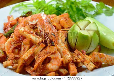spicy stir fried prawn with coconut shoot on dish