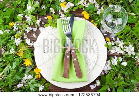 Summer table settings with flowers cutlery and wineglass. Floral wedding table settings in rustic style. Holidays background. Top view
