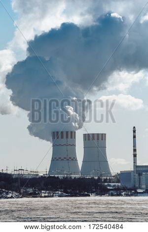 Cooling towers of NPP or Nuclear Power Plant with thick smoke. Vertical image
