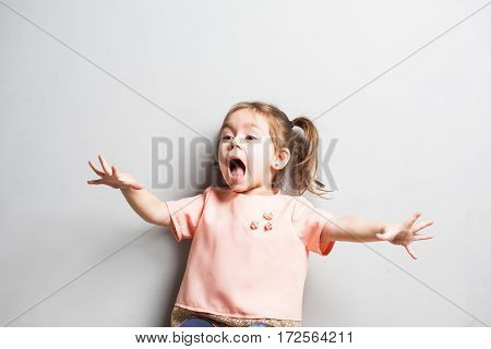 Little cute girl screaming or scearing surprized